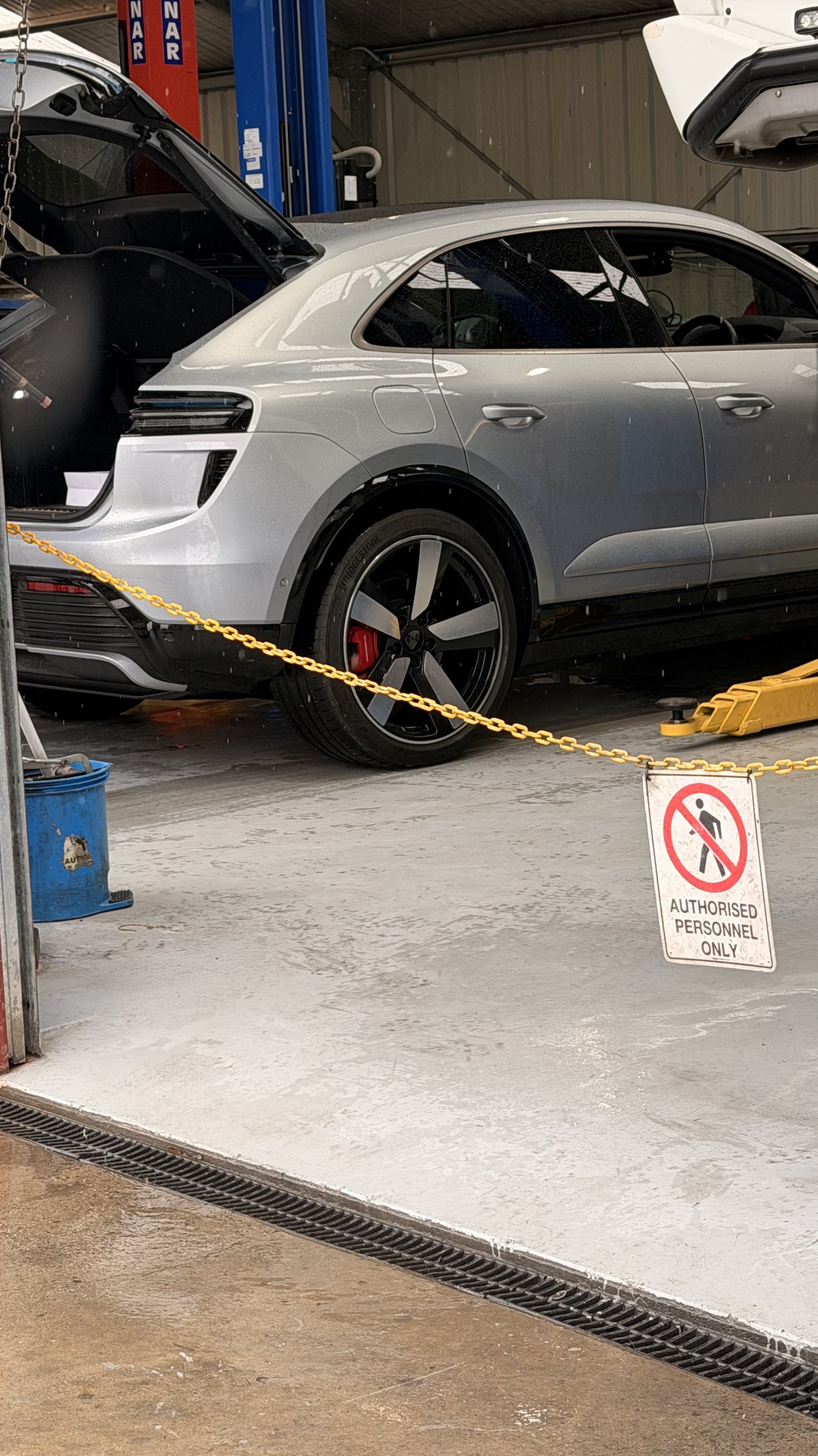 A late model Porsche Macan in one of the workshop bays